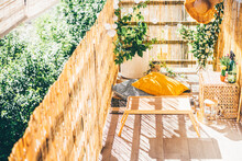 Eco Friendly Bamboo Terrace. Orange Pillows On The Floor.