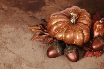 Sticker - Rustic pumpkin and acorns on brown fall season texture background.