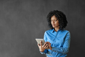 Businesswoman working on a table in front of a chalkboard