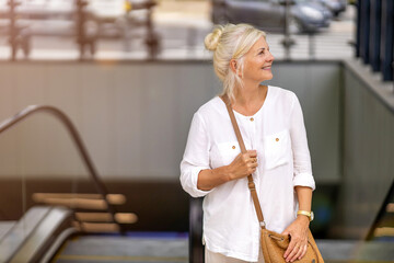 Wall Mural - Portrait of senior woman smiling in the city
