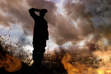 Wall Mural - Silhouette of soldier saluting on battlefield. Military service