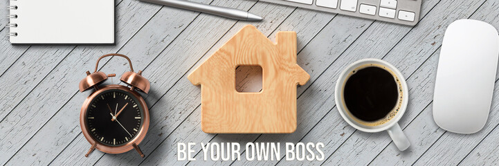 Wall Mural - office equipment and wooden house symbol with message BE YOUR OWN BOSS on wooden background