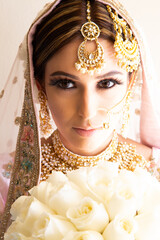 Beautiful Sikh bride wearing traditional wedding attire and jewelry