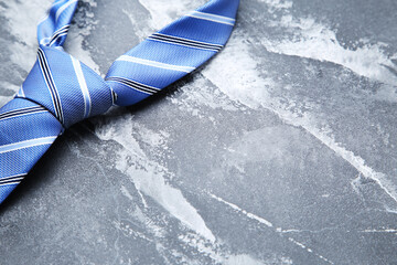 Wall Mural - Blue necktie on grey background