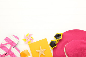 Poster - Summer straw hat with flip flops, sunglasses, notepad and starfish on white wooden table