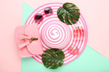 Wall Mural - Summer straw hat with sunglasses, perfume bottle, monstera leafs and handbag on colorful paper background