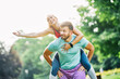 © Lumos sp - fitness woman park exercise lifestyle outdoor sport healthy couple nature active young fit fun piggyback