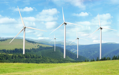 alternative energy source. wind turbines in mountains under blue sky