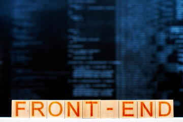 front end concept. wooden blocks with the inscription front-end with program code on the background