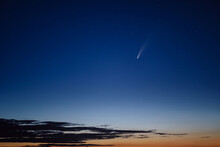 Comet In The Night Sky At Sunset