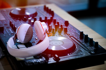 a DJ or music mixer play sound disc audio in a party, player acting with wear sound head set