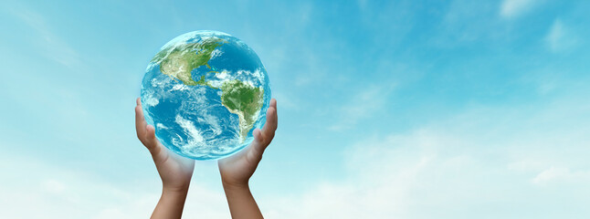 concept- boy holding planet earth in his hands- elements of this image furnished by nasa