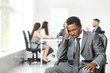 © Pixel-Shot - Lonely African-American businessman in office. Stop racism