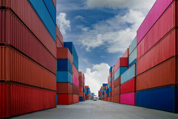 Wall Mural - Stack of container box in transportation port with blue sky