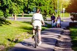 Fototapeta  - Cyclist ride on the bike path in the city Park
