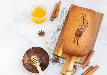 Poster - Spicy honey cake with cinnamon and anise star on light grey concrete background. Honey cake for Rosh Hashanah. Top view, copy space.