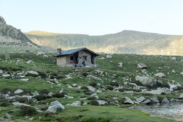 Sticker - Beautiful shot of a small house in a mountain landscape under the sunlight