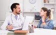 © JackF - Teenage girl with sore throat and cold visiting man doctor in hospital