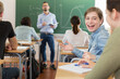 © JackF - Young girls are sitting at the desk and talking in time lecture in the classroom in the school.
