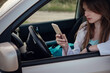 © Olena_Molchanova - a beautiful young woman driving a grey car.
