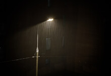 Heavy Rain Under Night Street Lamp Lights , Rainstorm,Grained Image.