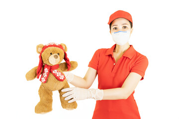 Staff,Asian Delivery in red uniform isolated on white background.Courier in protective mask and medical gloves,concept delivers service under quarantine