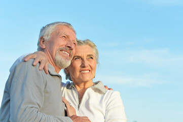 Wall Mural - Close-up portrait of happy senior couple hugging