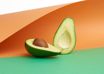 Wall Mural - half ripe green avocado with a brown bone