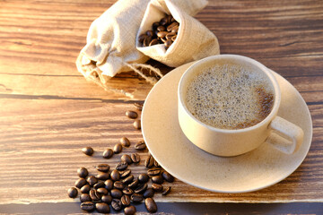 Top view coffee cup and coffee beans on wood table, space for text