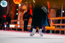 Low Section Of Person Ice-skating During Christmas At Night