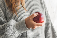Midsection Of Woman Holding Red Apple.