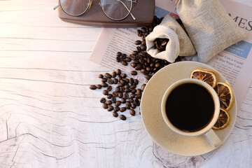 Poster - Top view coffee cup and coffee beans on wood table, space for text