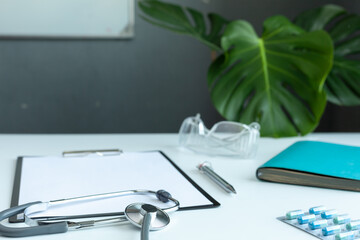 Doctor general practitioner desk. Healthcare insurance concept. Table top view essential doctor's equipment