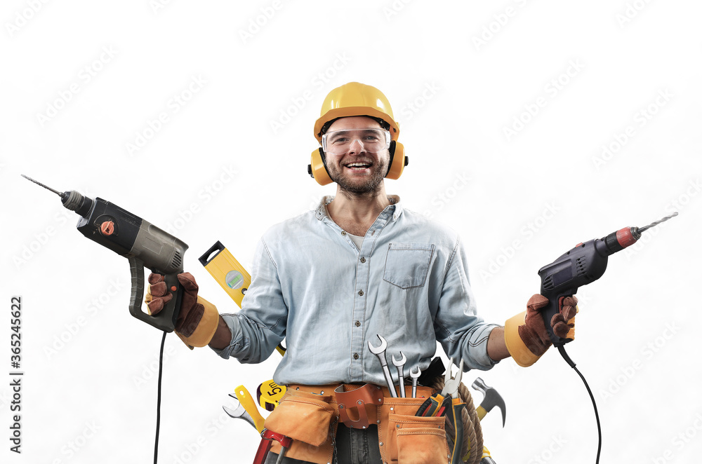 Construction worker in dirty clothes with a hammer and drill at work - obrazy, fototapety, plakaty 