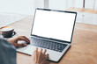 © panitan - computer mockup image blank screen.hand woman work using laptop with white background for advertising,contact business search information on desk at coffee shop.marketing and creative design