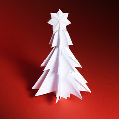 Wall Mural - Christmas trees made of paper on red background. Christmas card