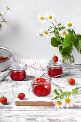 Wall Mural - Strawberry jam in glass jar on the white wooden table