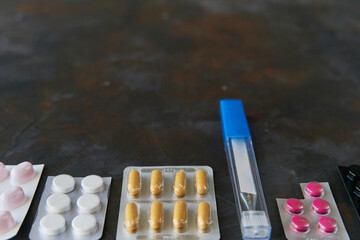 Wall Mural - Pills capsules medicine health on dark background top view, medical pharmacy concept. Different pills on dark background with copy space.