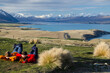 Two people laying and looking at Lake tekapo from Mount John observatory, South Island, New Zealand