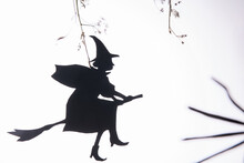 Black Paper Silhouette Of A Witch Flying To Sabbath On Halloween Night, On White Background. Homemande Halloween Decoration, DIY. Trendy Halloween Minimal Card Or Poster