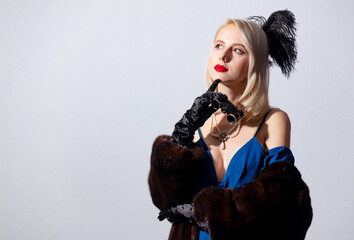 Poster - Blonde woman in vintage blue dress and fur coat with opera glasses