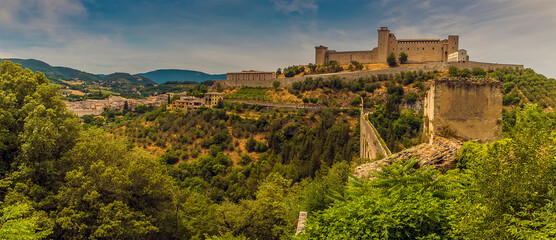 A fortress looks down on the Tower Bridge and gorge at Spoleto, Italy in summer