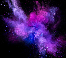 Wall Mural - Colored powder explosion on black background. Freeze motion.