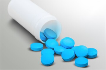 Poster - Medical colored pills in the plastic bottle on the desk