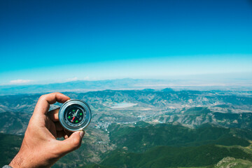 view from the top of the mountain to the mountains and the compass