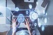 © peshkova - Double exposure of woman hands working on computer and data theme hologram drawing. Top View. Technology concept.