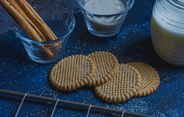 cinnamon cookies sprinkled with sugar on a blue rustic background