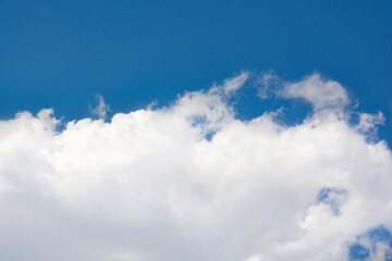snow-white clouds against a blue sky