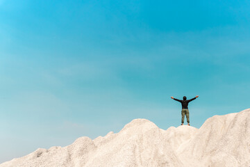 Wall Mural - Man rise hands up to sky freedom concept with copyspace blue sky.