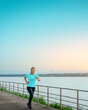 © ParinPIX - Asian woman is running and jogging an outdoor workout on the riverwalk in the morning for lifestyle health.